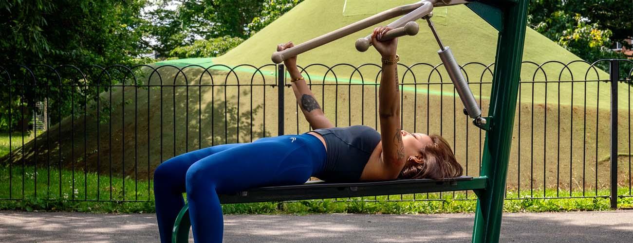 lady using fresh air fitness resistance bench press