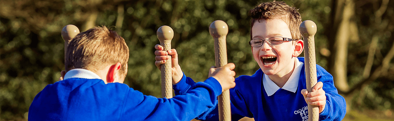 boys using outdoor gym equipment