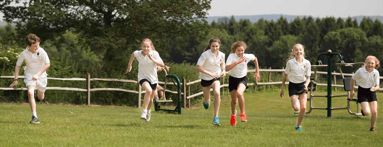 Children Exercising in School Field