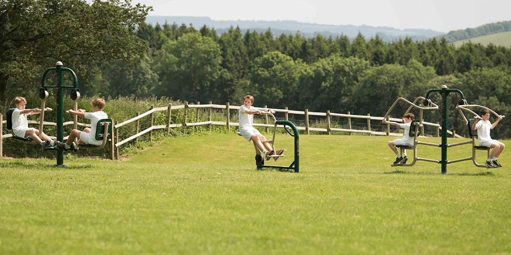 children at secondary using outdoor gym